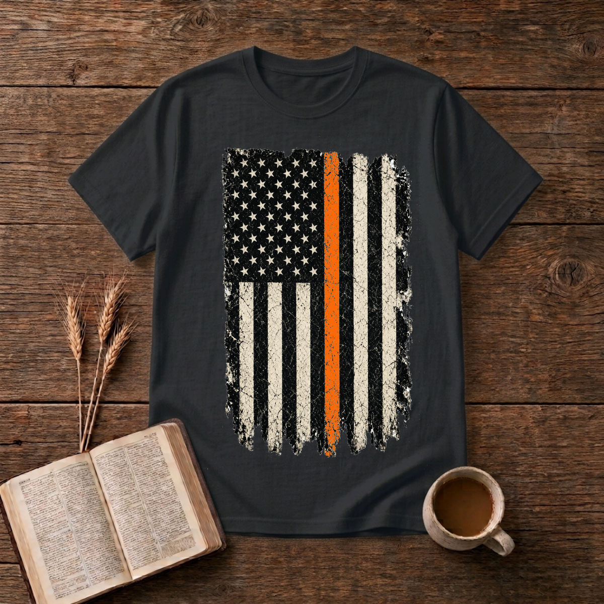 Distressed monochrome American flag with a thin orange line on a Black unisex T-Shirt