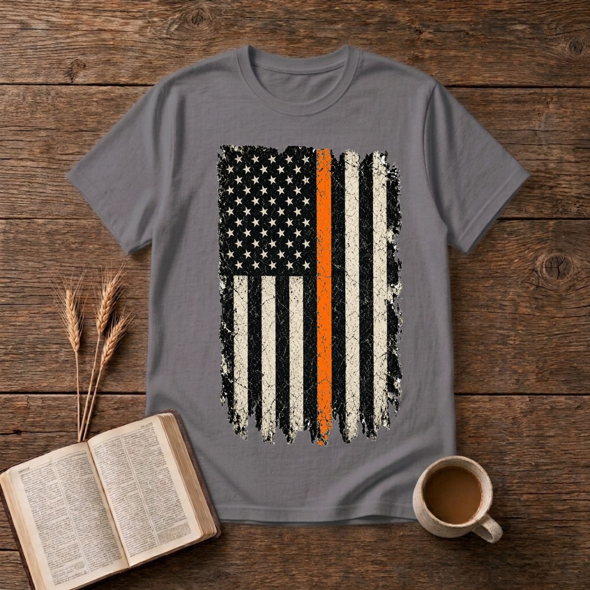 Distressed monochrome American flag with a thin orange line on a Charcoal unisex T-Shirt