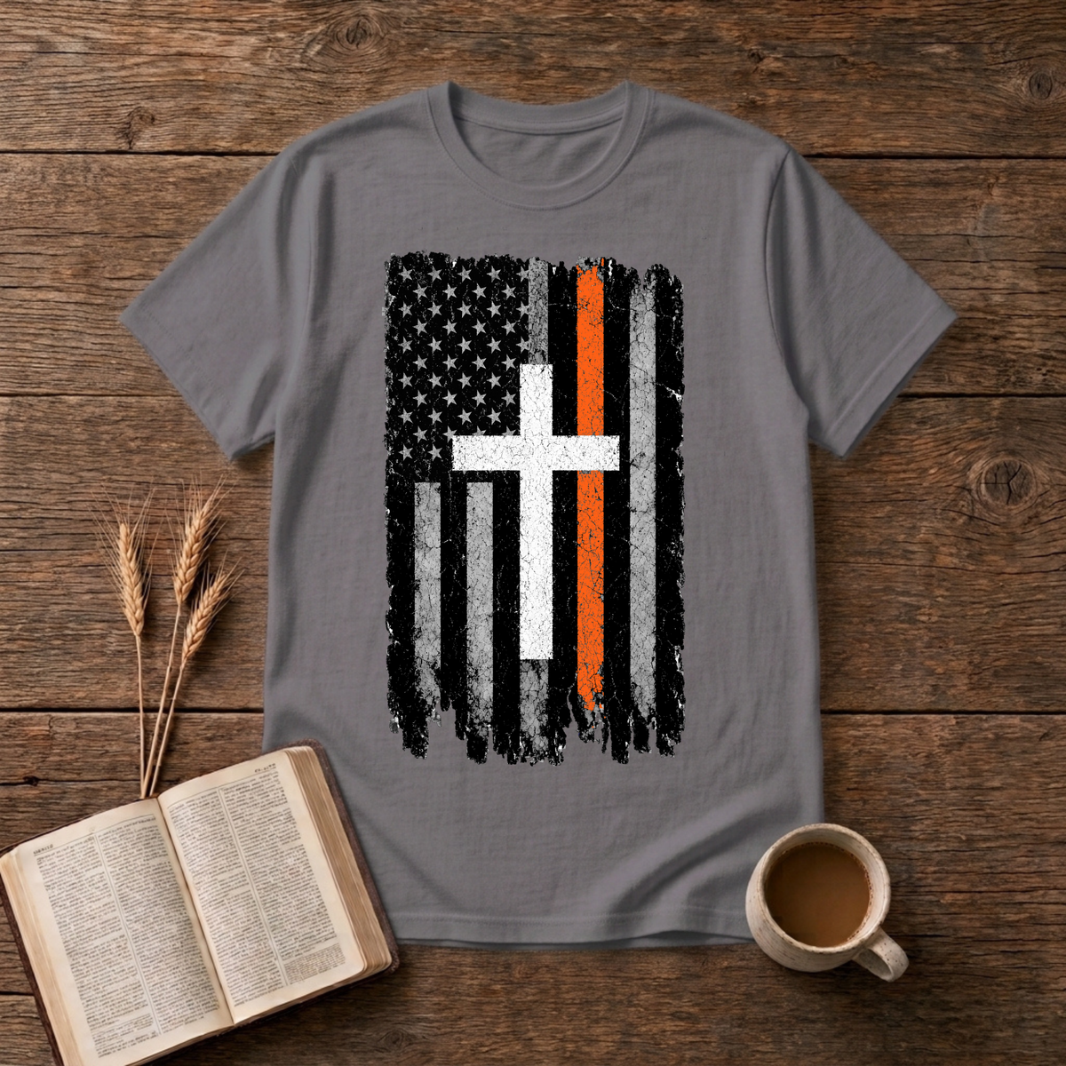 Distressed monochrome flag with a thin orange line and cross silhouette on a Charcoal unisex T-Shirt