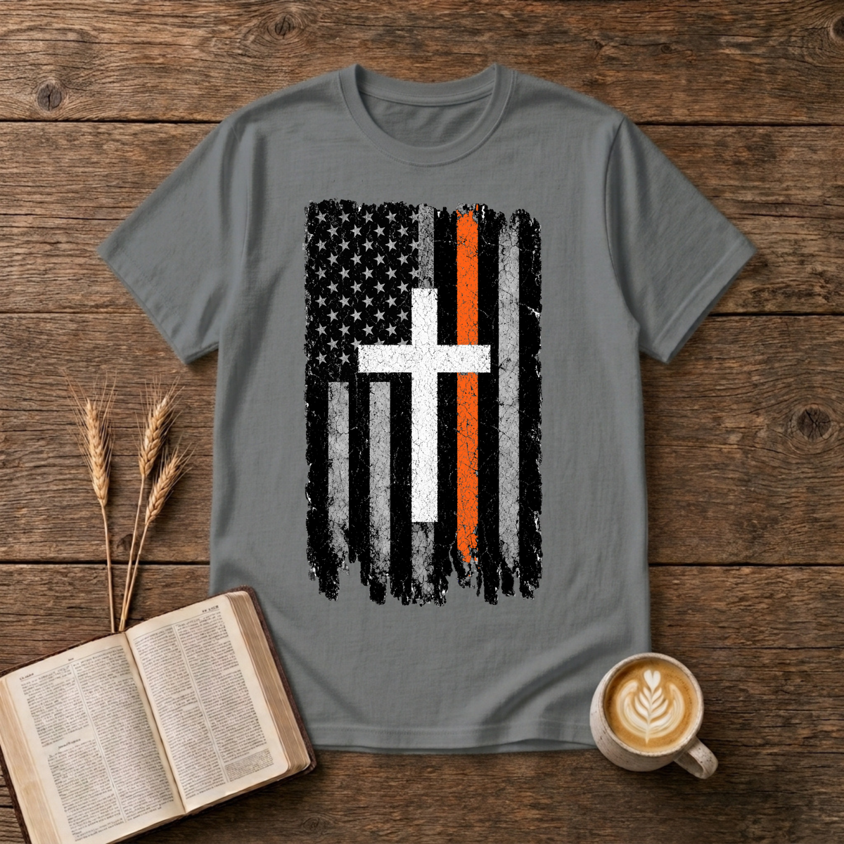 Distressed monochrome flag with a thin orange line and cross silhouette on a Graphite Heather unisex T-Shirt