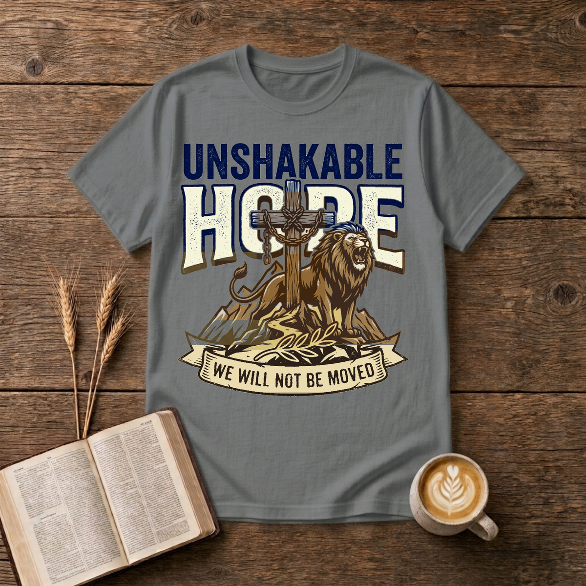 UNSHAKABLE HOPE lettering above a cross and lion illustration on a Graphite Heather unisex T-Shirt