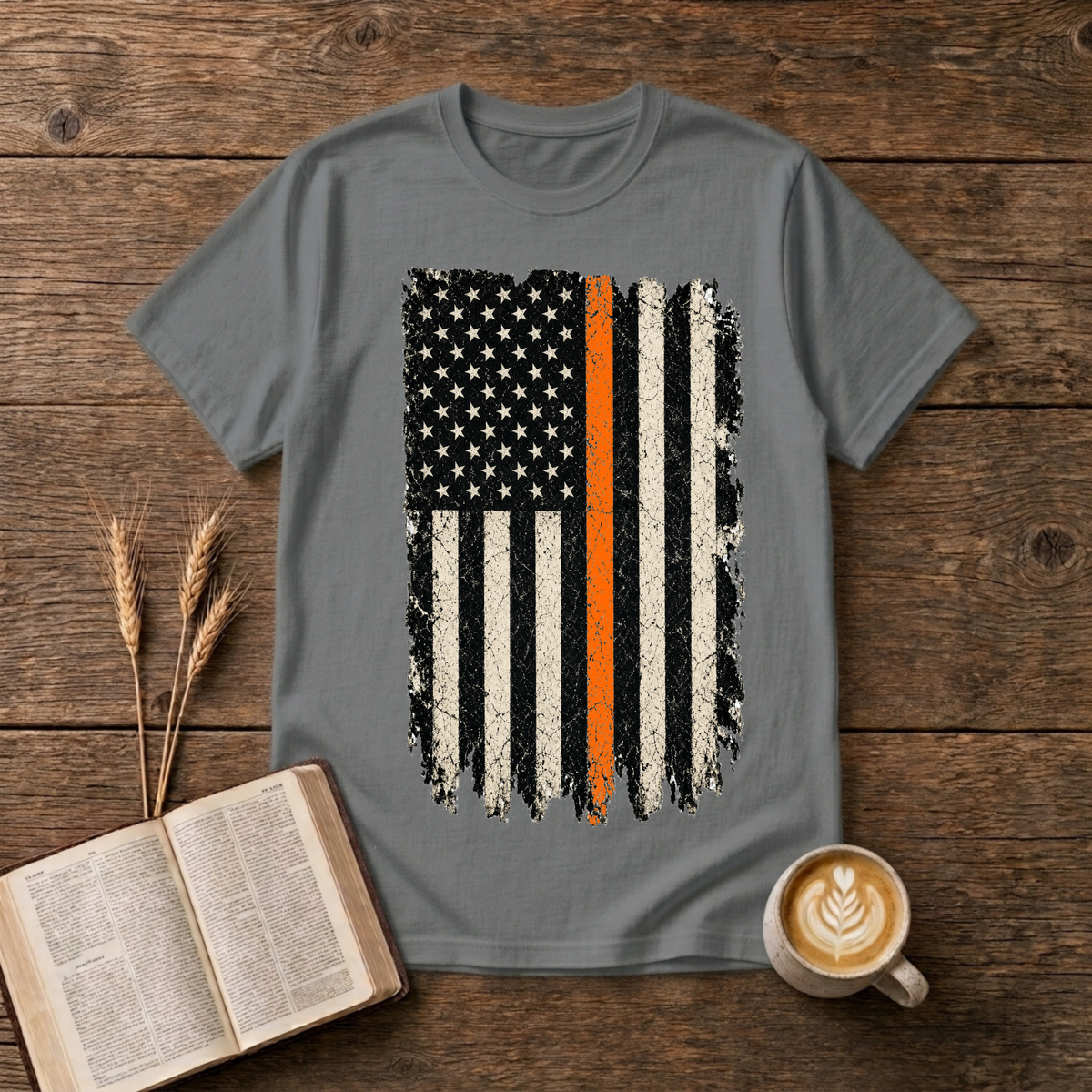 Distressed monochrome American flag with a thin orange line on a Graphite Heather unisex T-Shirt