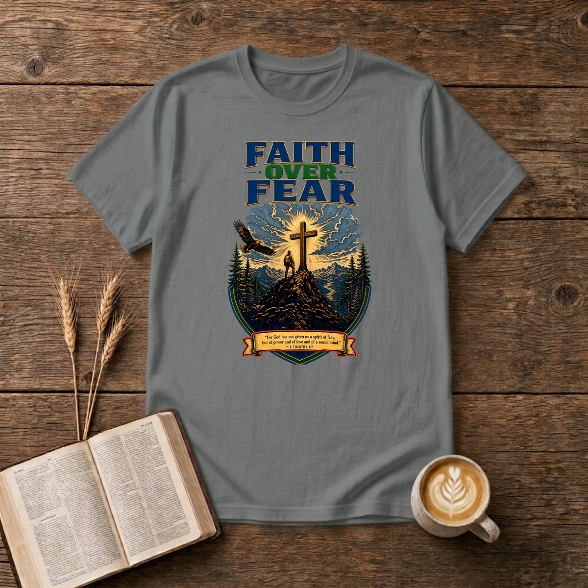 Faith Over Fear lettering over a mountain silhouette, pines and glowing cross on a Graphite Heather unisex T-Shirt
