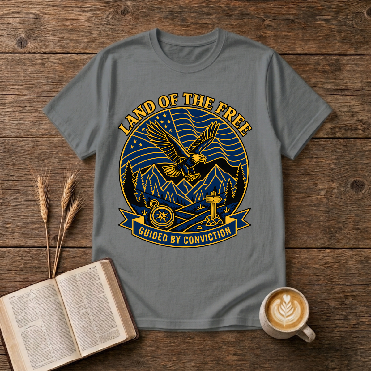 Bold monochrome emblem of an eagle in flight above mountains on a Graphite Heather unisex T-Shirt