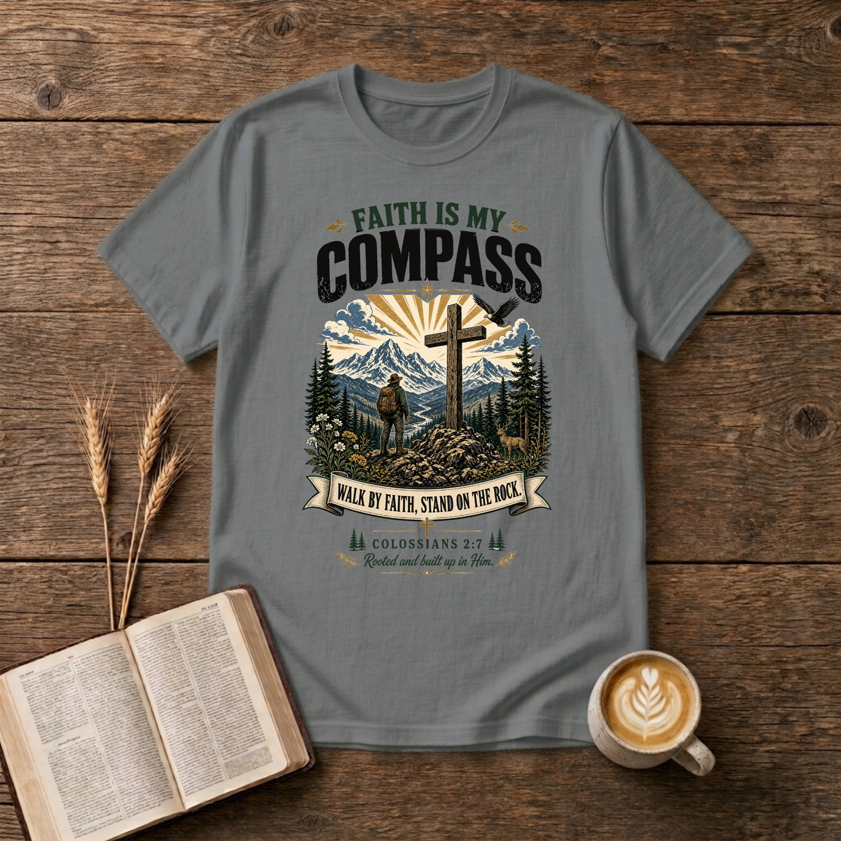 Faith Is My Compass lettering above a weathered cross amid pines and a rising sun on a Graphite Heather unisex T-Shirt