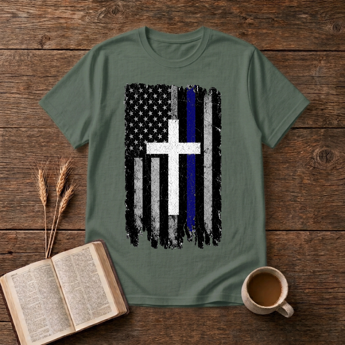 Faded black and white American flag with a thin blue line and cross on a Military Green unisex T-Shirt