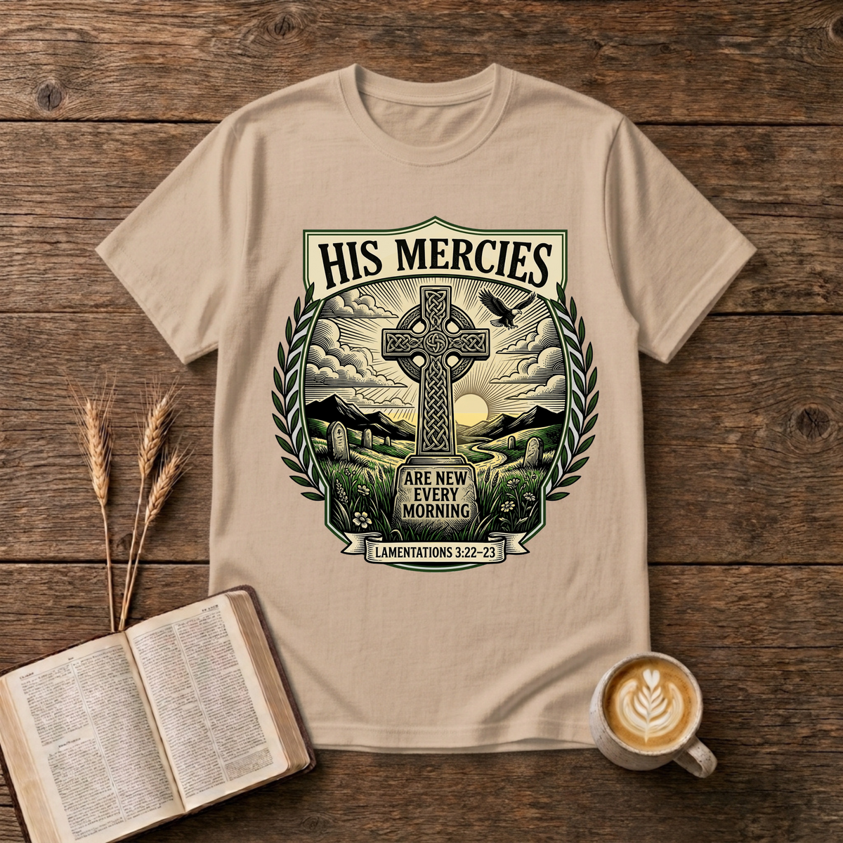 Monochrome Celtic cross against a dawn sky framed by laurel leaves with His Mercies on a Natural unisex T-Shirt