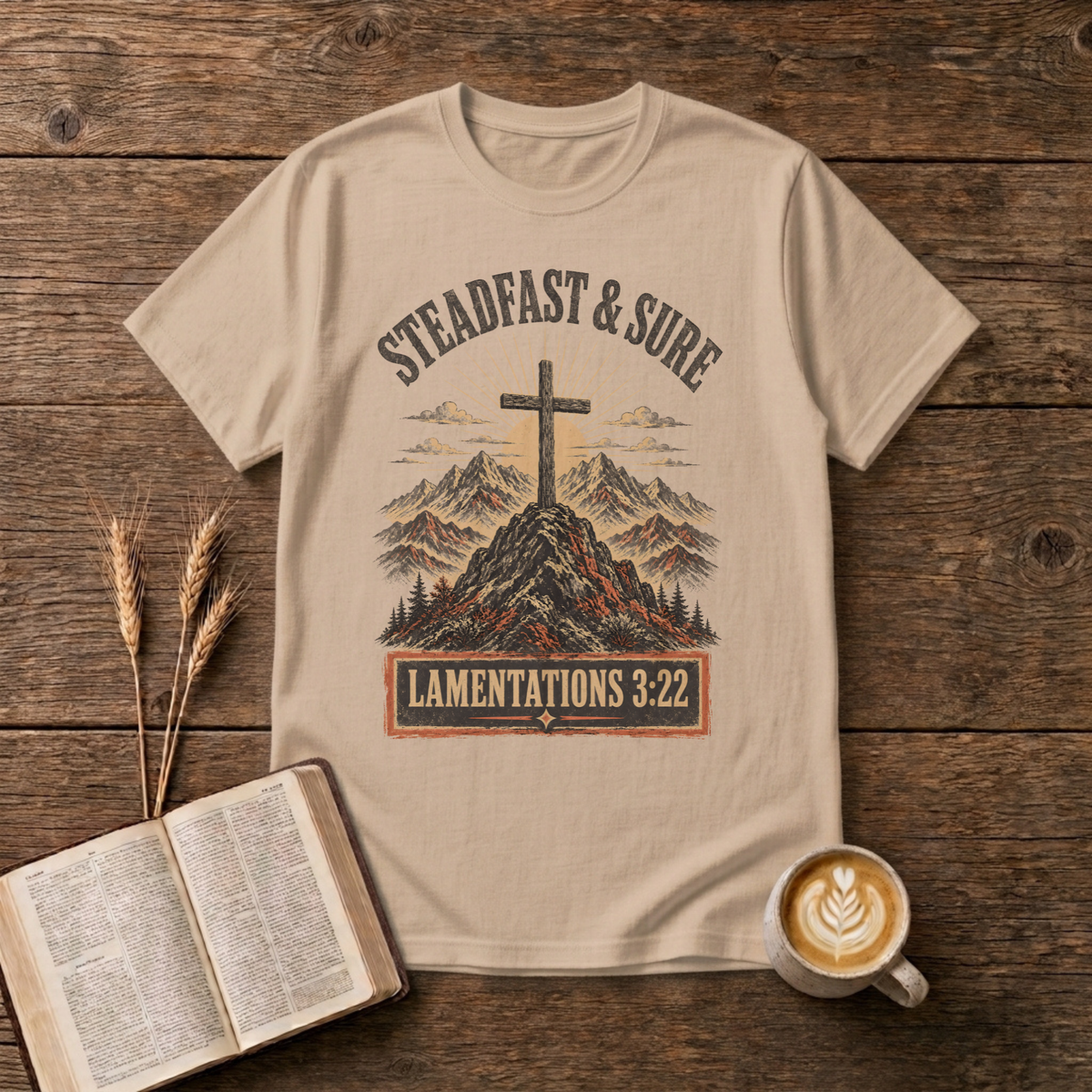 Steadfast and Sure lettering above a cross atop a rocky peak on a Natural unisex T-Shirt
