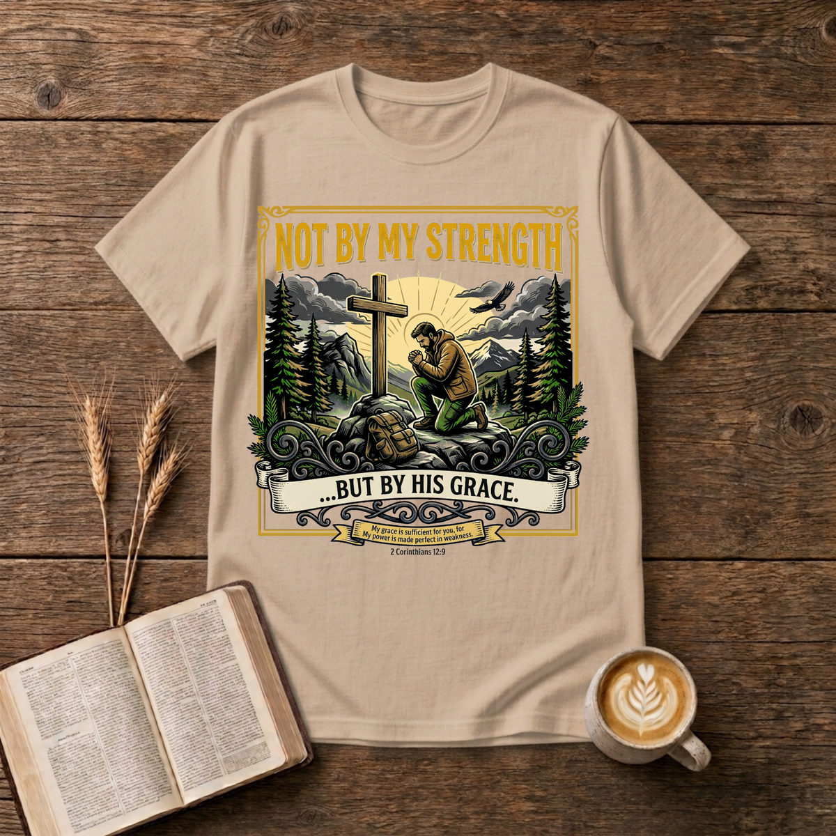 Figure kneeling at a cross in a forest clearing with Not By My Strength on a Natural unisex T-Shirt