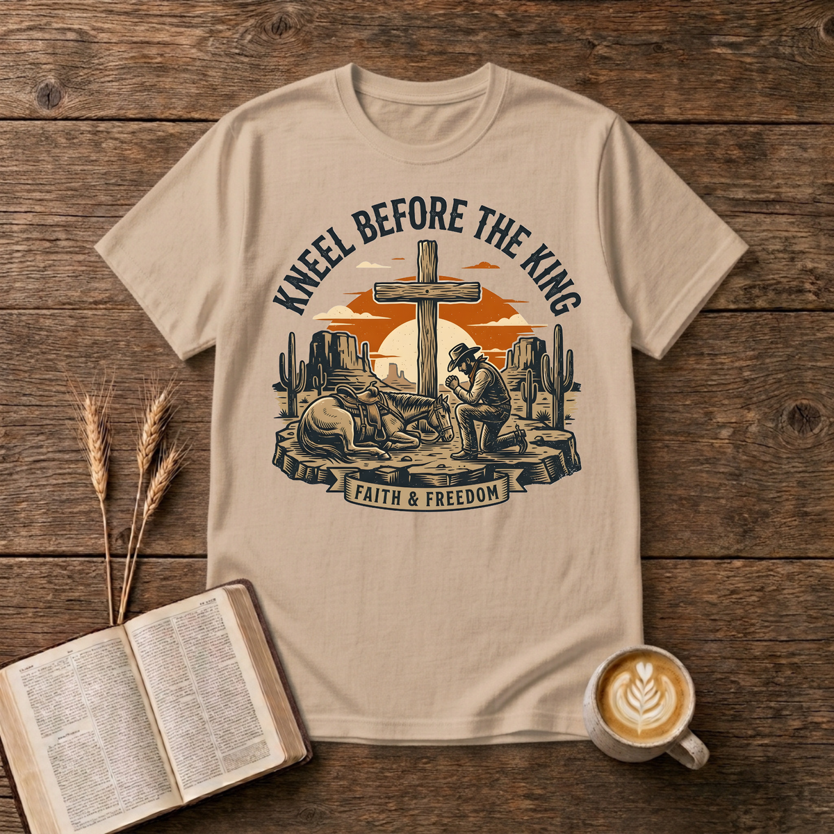 Cowboy kneeling in prayer beside his horse at a wooden cross in a desert sunset on a Natural unisex T-Shirt