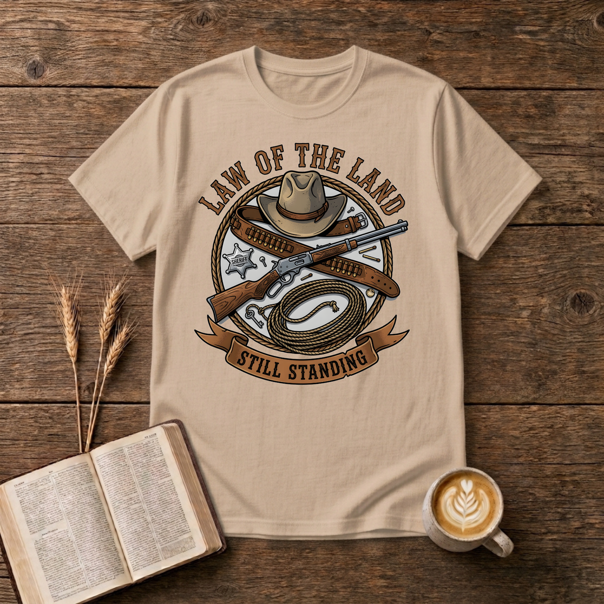 Western lawman emblem with cowboy hat, sheriff star, gun belt, lariat and rifle on a Natural unisex T-Shirt