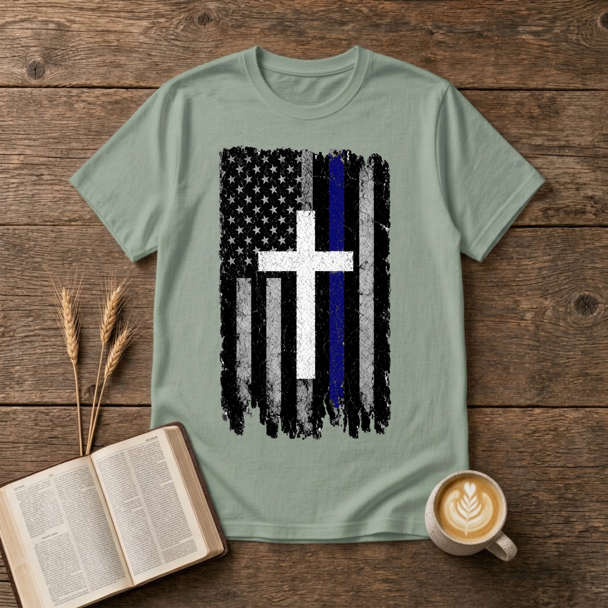Faded black and white American flag with a thin blue line and cross on a Sage unisex T-Shirt