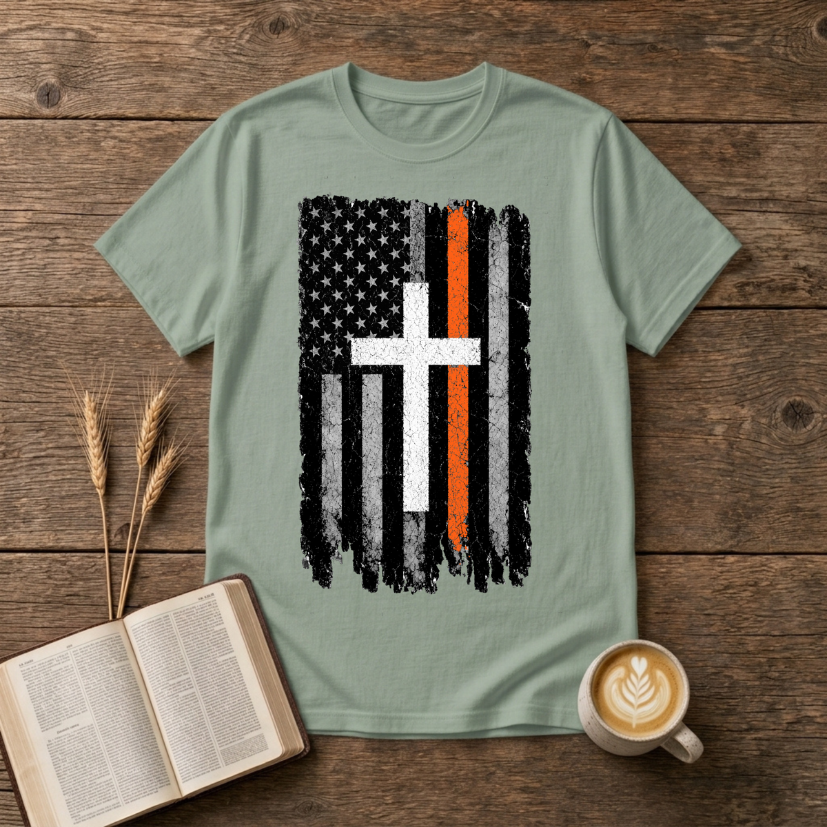 Distressed monochrome flag with a thin orange line and cross silhouette on a Sage unisex T-Shirt