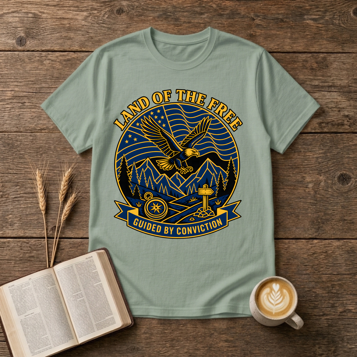 Bold monochrome emblem of an eagle in flight above mountains on a Sage unisex T-Shirt
