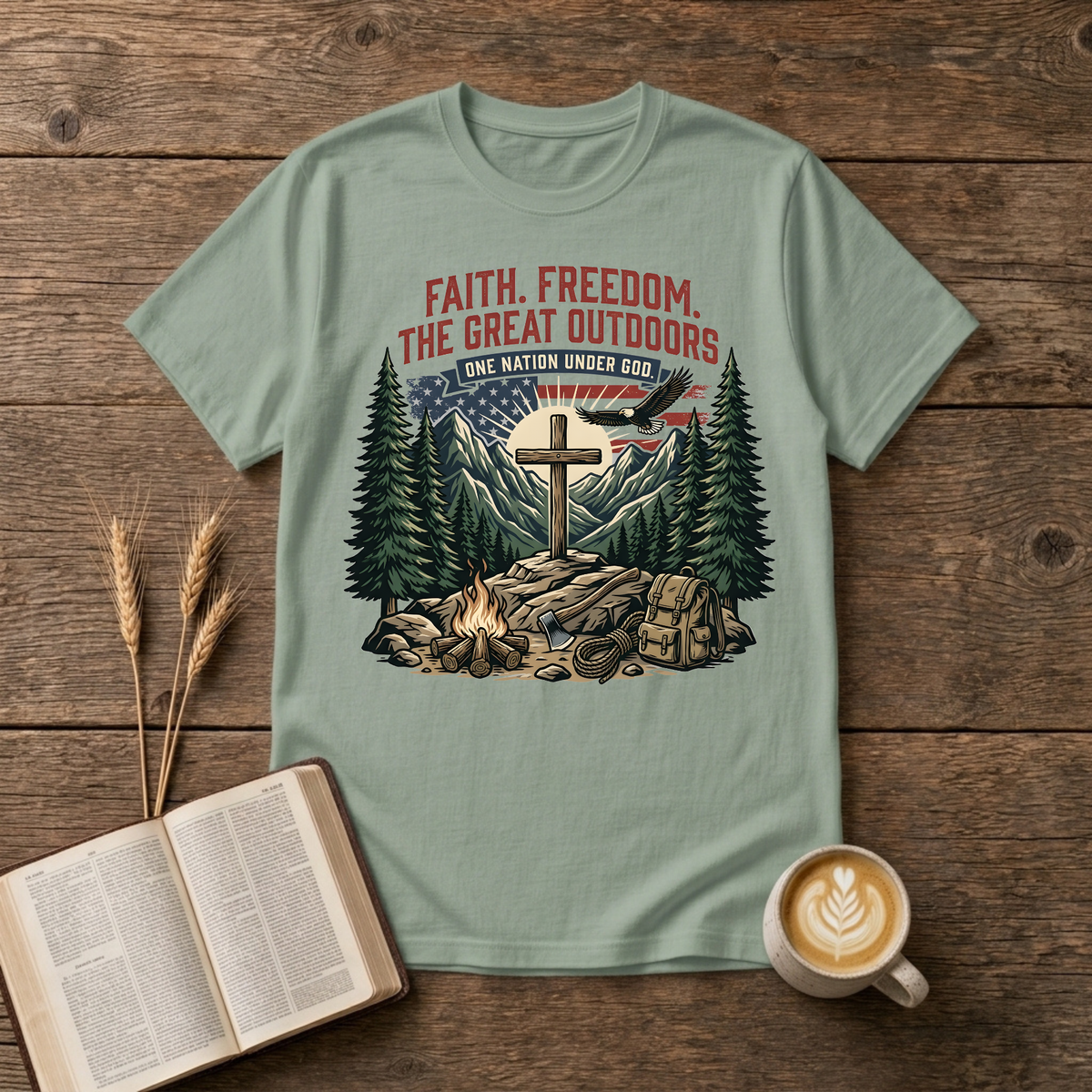 Wooden cross over a mountain at sunrise with pines, bald eagle and American flag on a Sage unisex T-Shirt