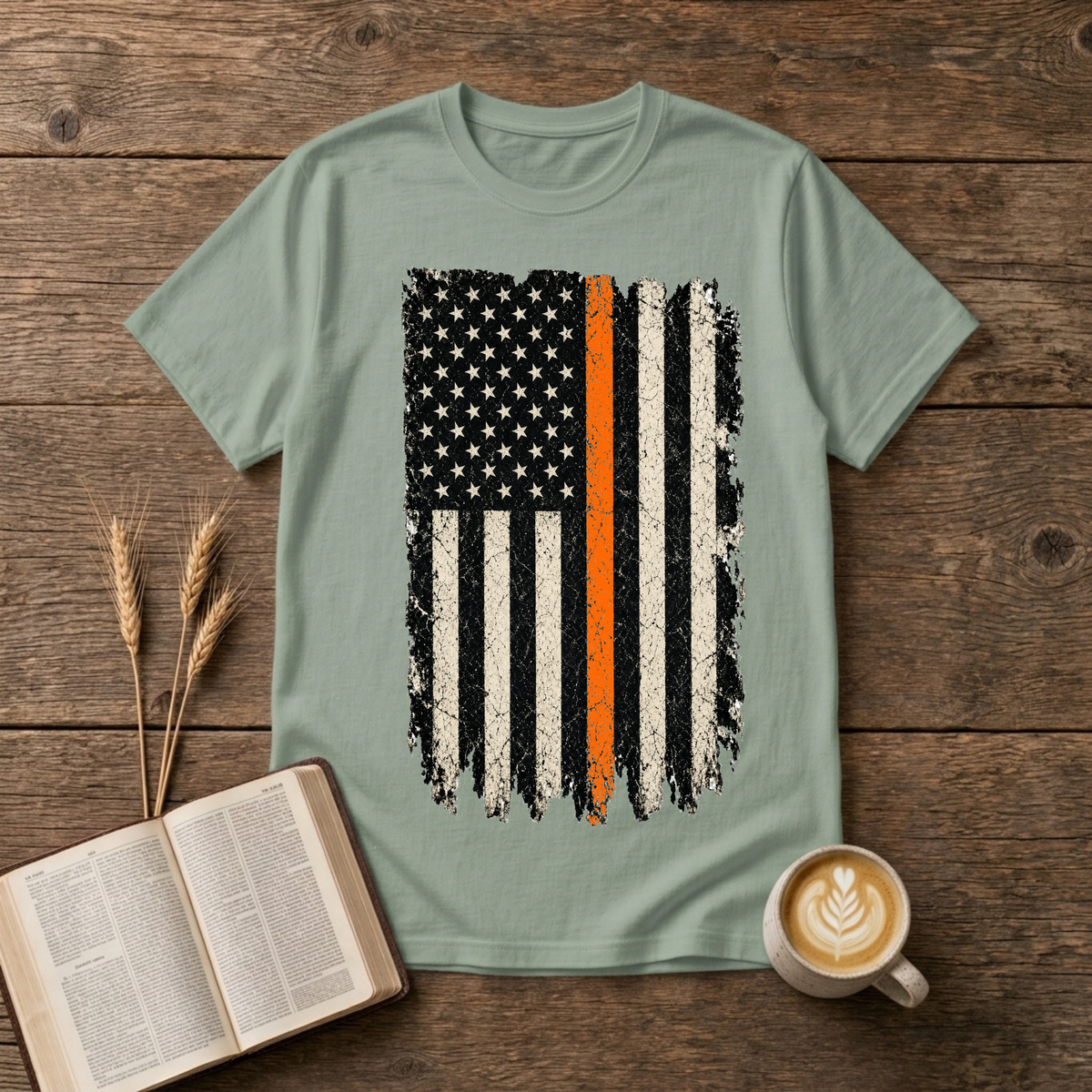 Distressed monochrome American flag with a thin orange line on a Sage unisex T-Shirt
