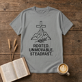 Line-drawn cross above stylized mountain peaks with Rooted Unmovable Steadfast on a Sport Grey unisex T-Shirt