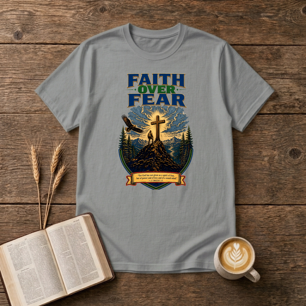 Faith Over Fear lettering over a mountain silhouette, pines and glowing cross on a Sport Grey unisex T-Shirt