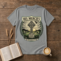 Monochrome Celtic cross against a dawn sky framed by laurel leaves with His Mercies on a Sport Grey unisex T-Shirt