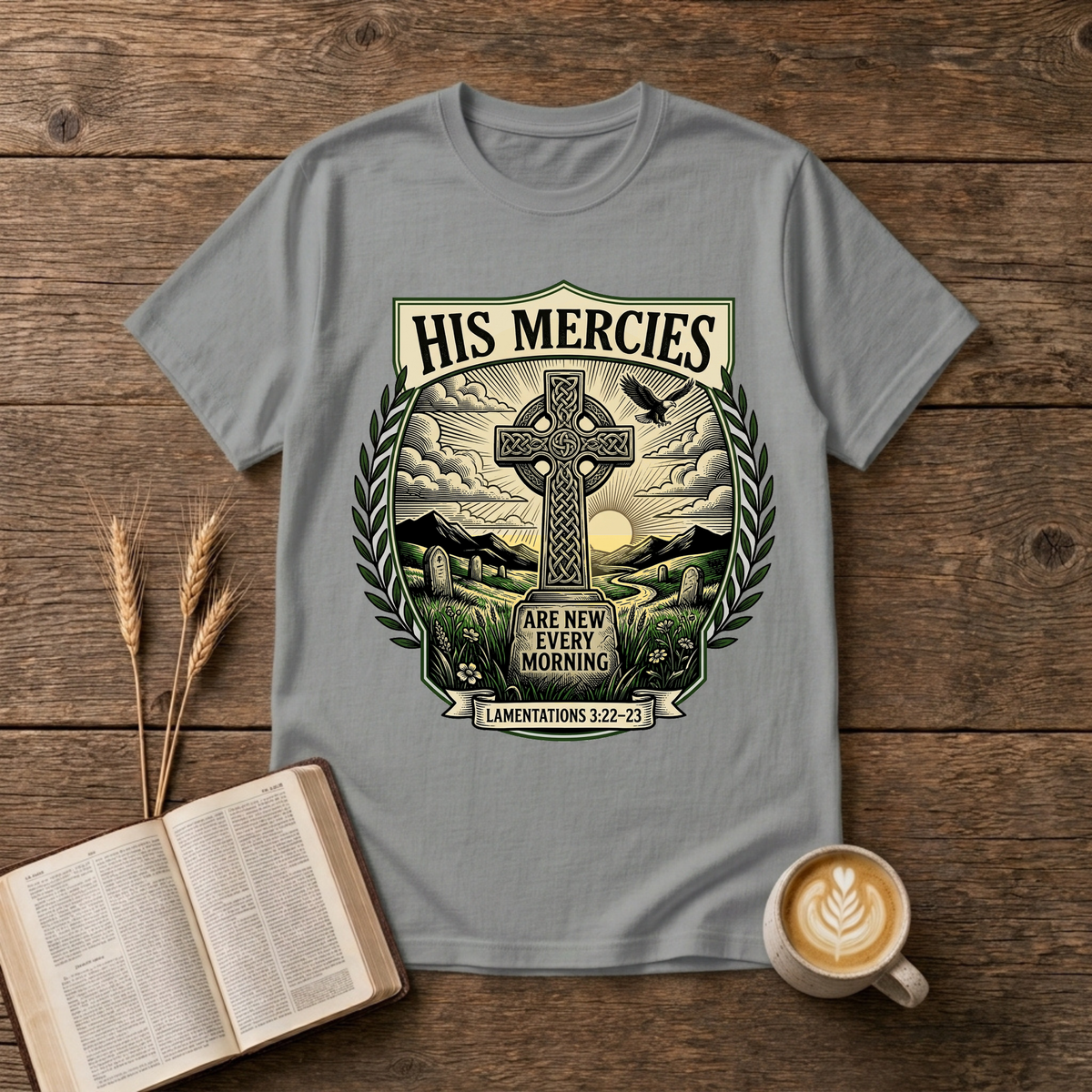 Monochrome Celtic cross against a dawn sky framed by laurel leaves with His Mercies on a Sport Grey unisex T-Shirt