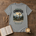 Faith Is My Compass lettering above a weathered cross amid pines and a rising sun on a Sport Grey unisex T-Shirt