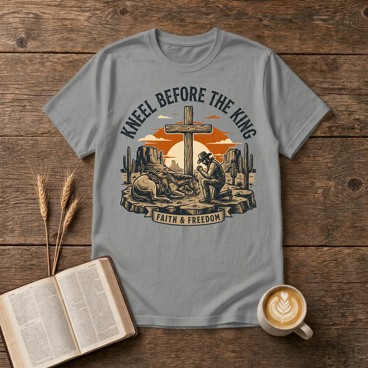 Cowboy kneeling in prayer beside his horse at a wooden cross in a desert sunset on a Sport Grey unisex T-Shirt