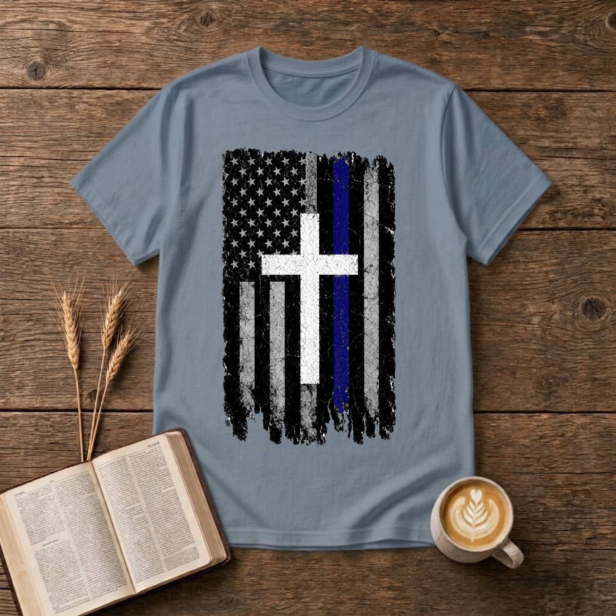 Faded black and white American flag with a thin blue line and cross on a Stone Blue unisex T-Shirt