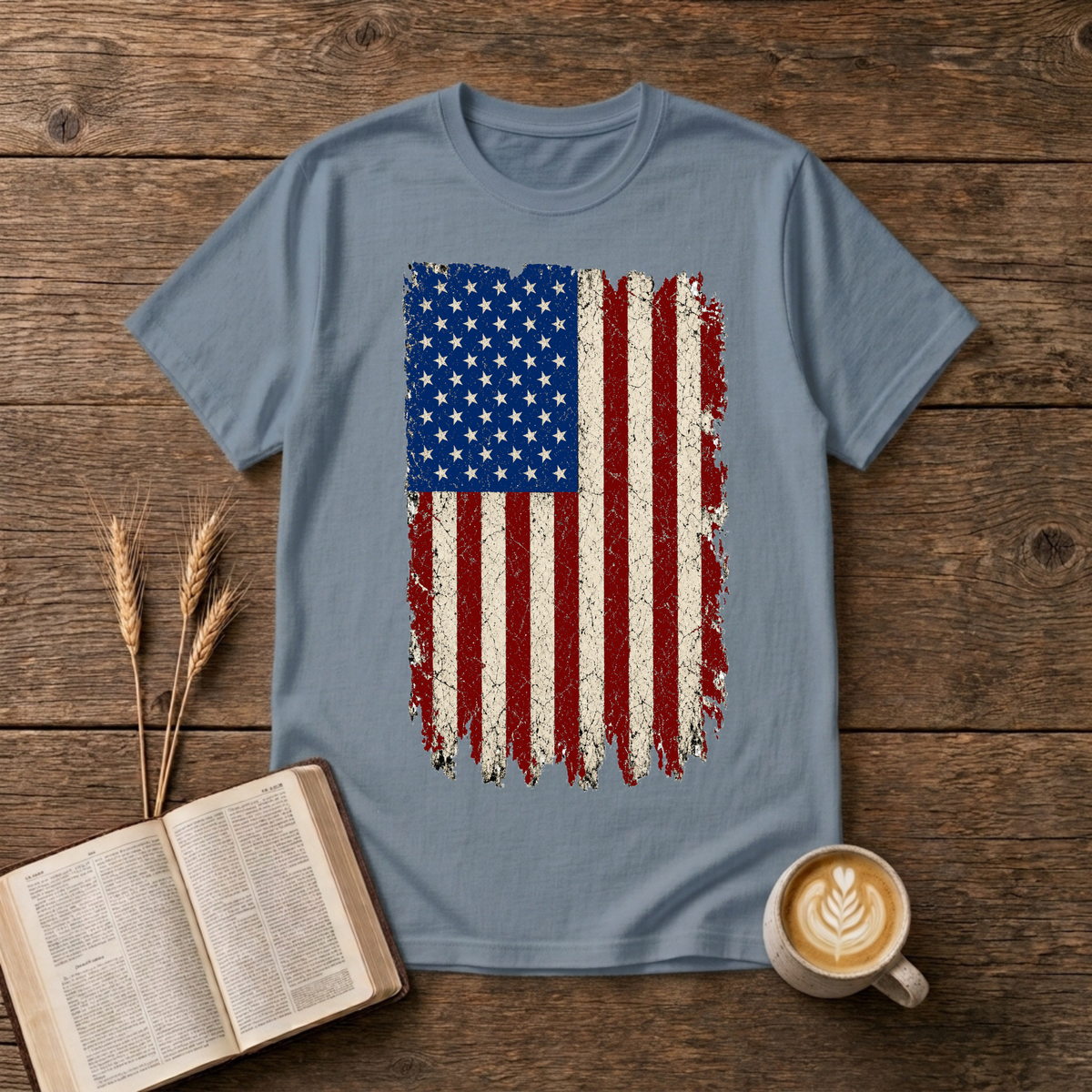 Distressed red, white and blue American flag with brushstroke edges on a Stone Blue unisex T-Shirt.