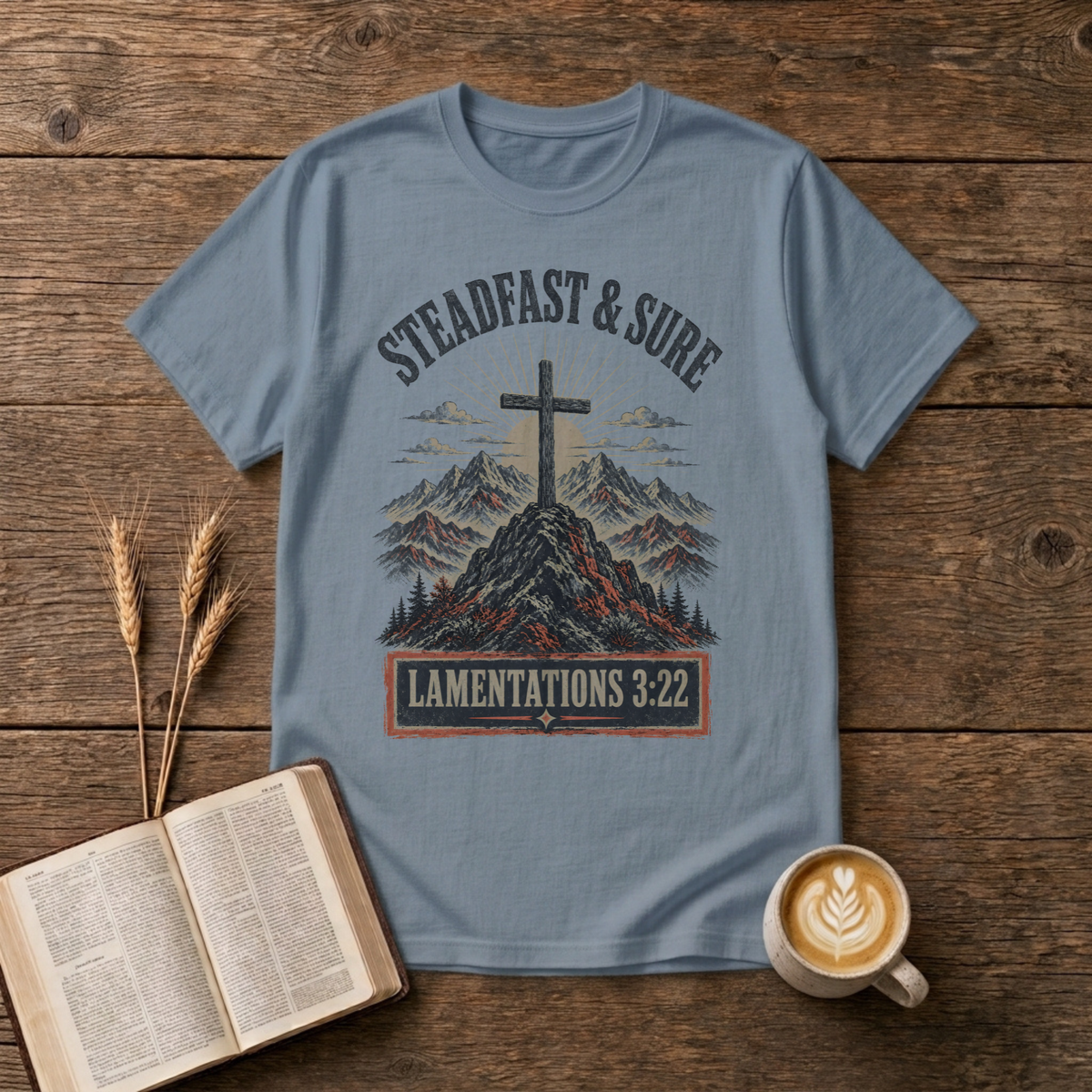 Steadfast and Sure lettering above a cross atop a rocky peak on a Stone Blue unisex T-Shirt