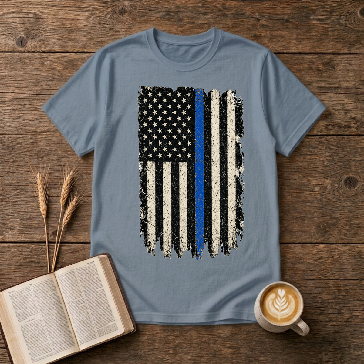 Distressed black and white American flag with a thin blue line on a Stone Blue unisex T-Shirt