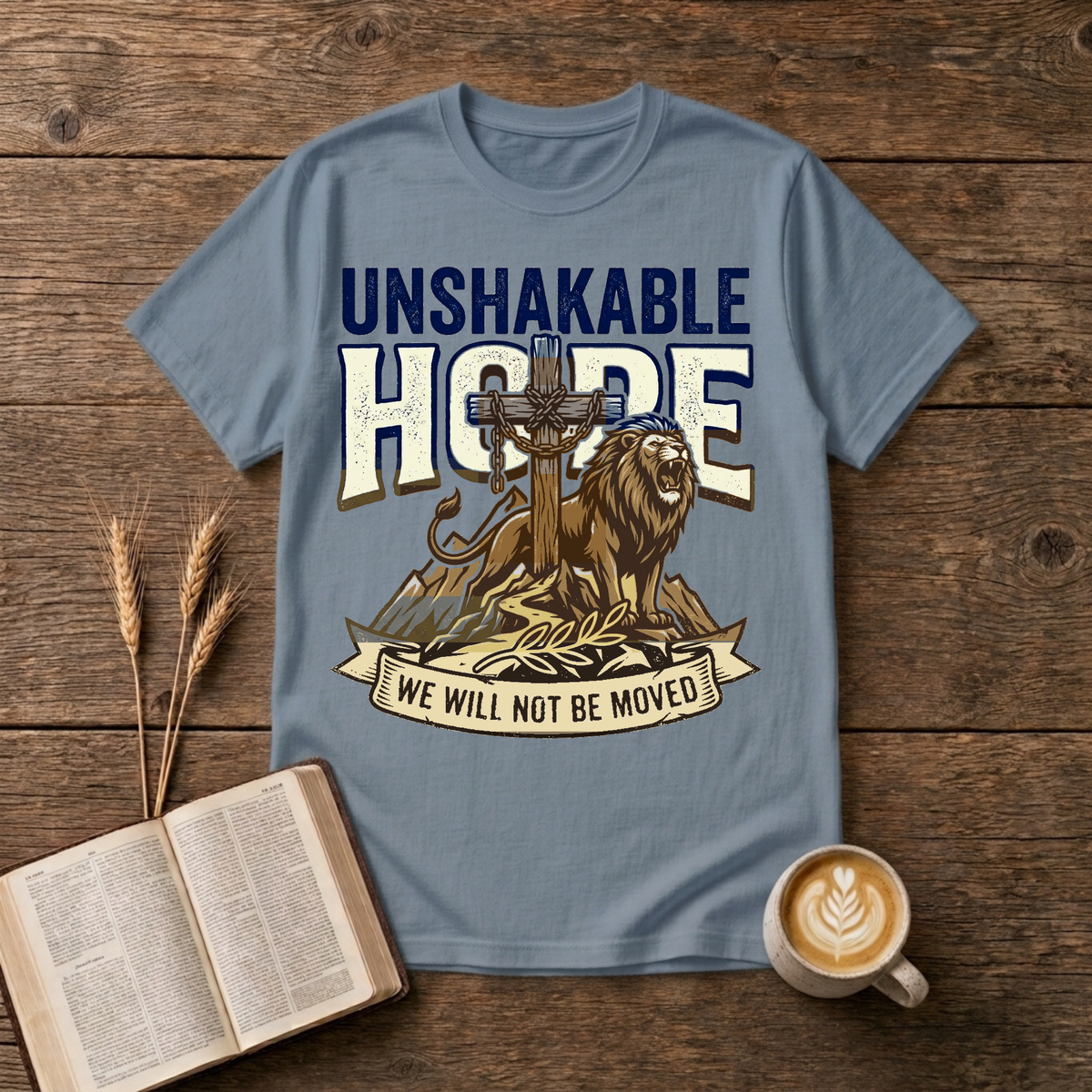 UNSHAKABLE HOPE lettering above a cross and lion illustration on a Stone Blue unisex T-Shirt