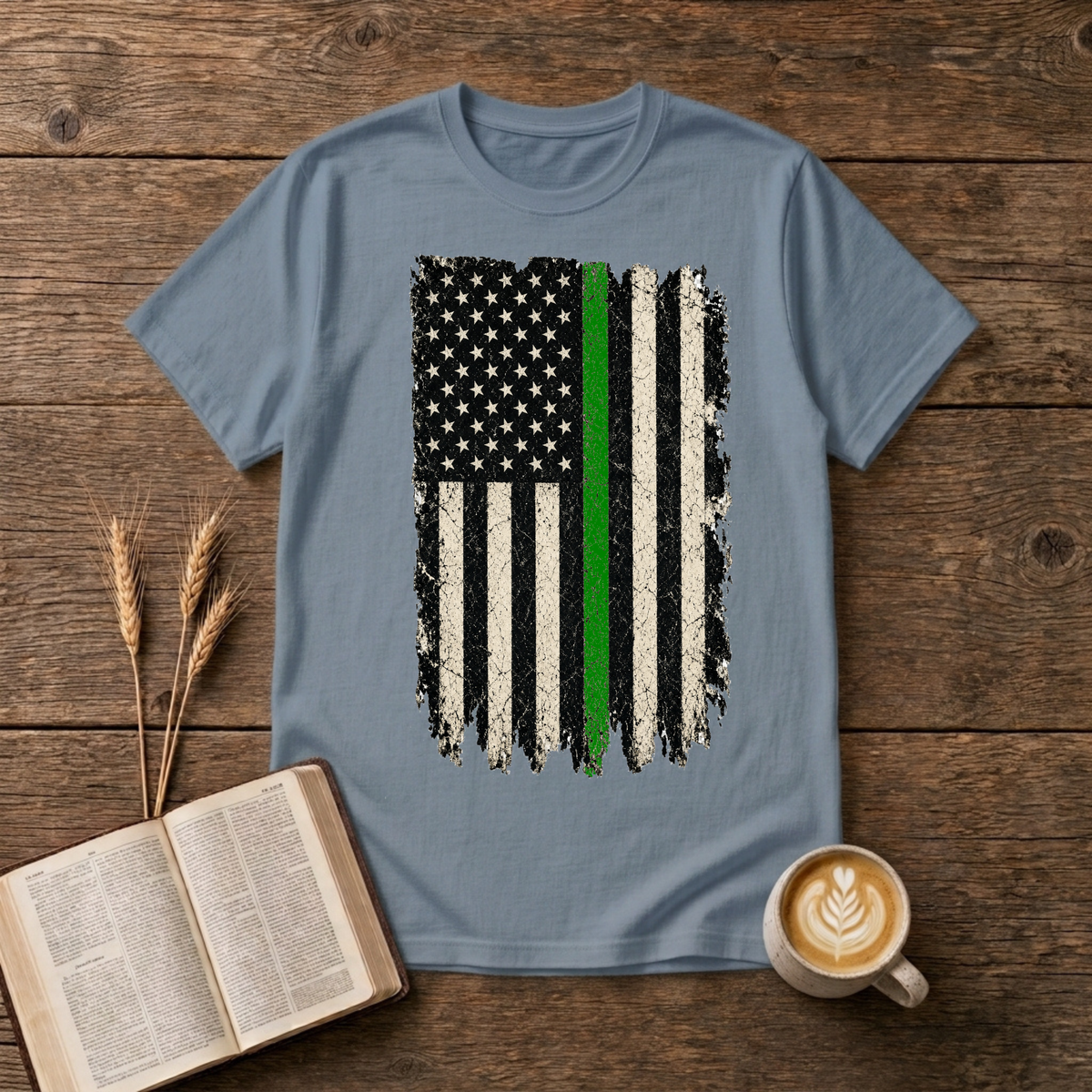 Distressed monochrome American flag with a thin green line on a Stone Blue unisex T-Shirt