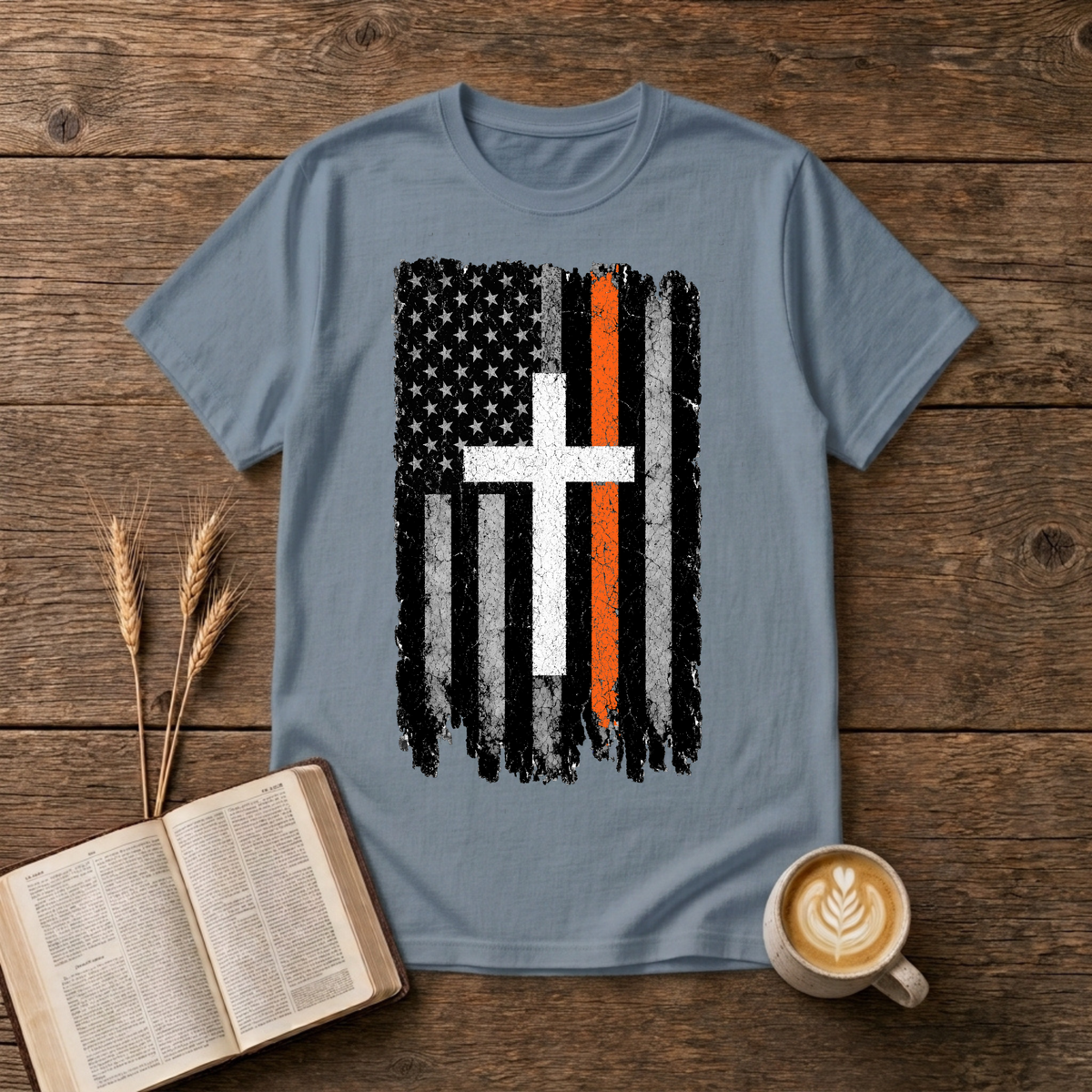 Distressed monochrome flag with a thin orange line and cross silhouette on a Stone Blue unisex T-Shirt