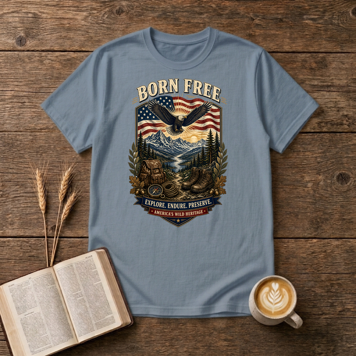 Born Free design of a soaring eagle over a waving American flag and pine-lined mountains on a Stone Blue unisex T-Shirt