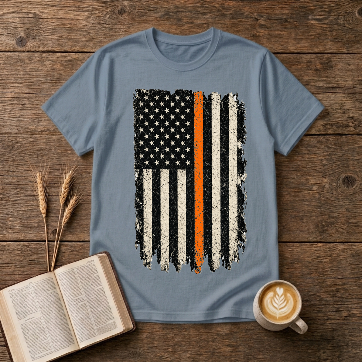 Distressed monochrome American flag with a thin orange line on a Stone Blue unisex T-Shirt