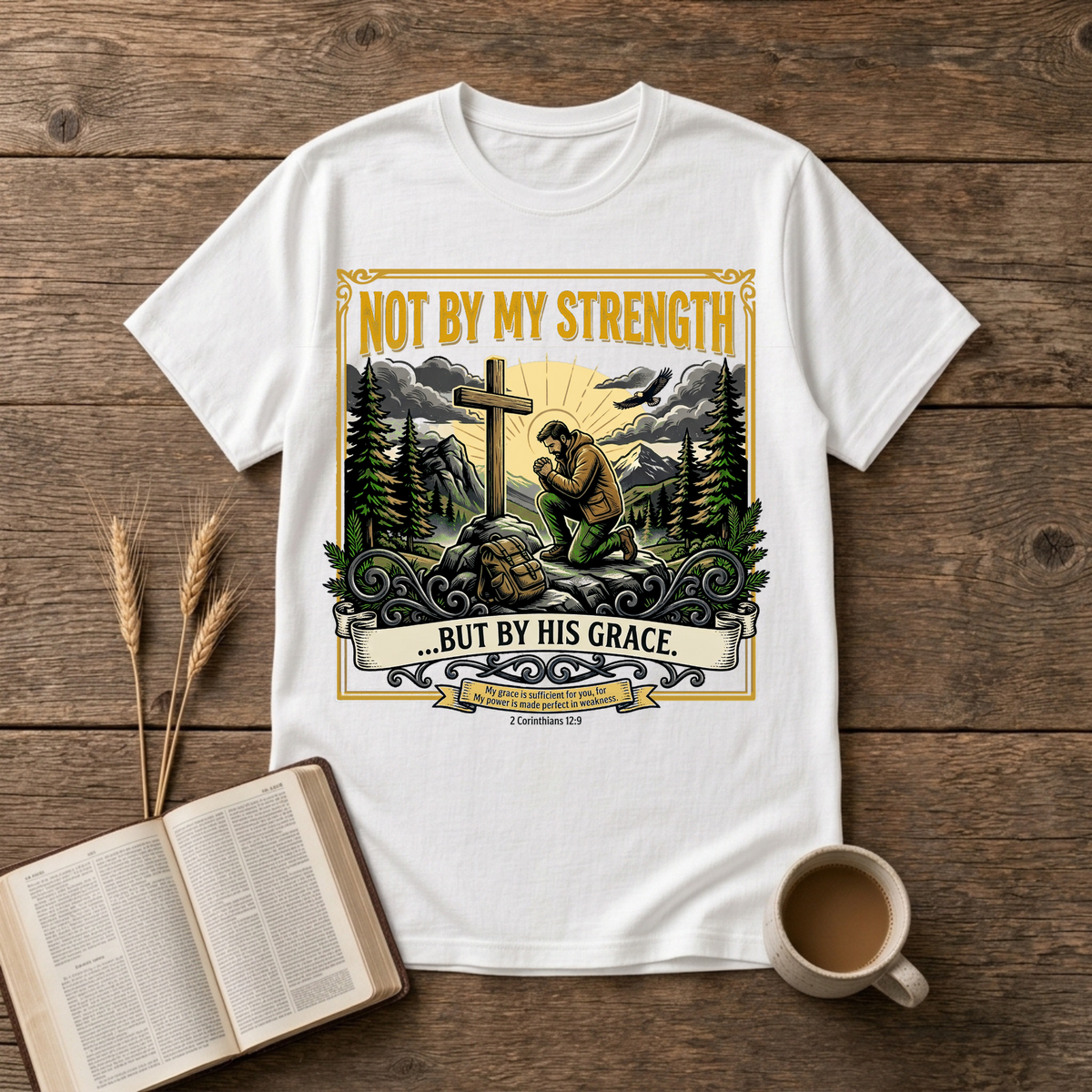 Figure kneeling at a cross in a forest clearing with Not By My Strength on a White unisex T-Shirt