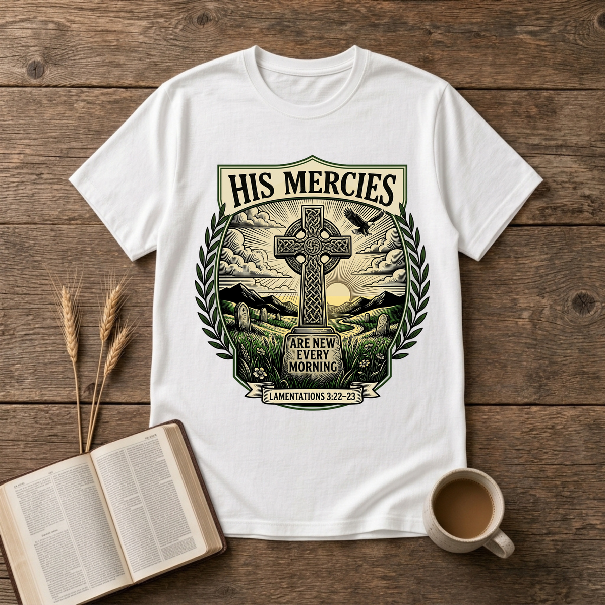 Monochrome Celtic cross against a dawn sky framed by laurel leaves with His Mercies on a White unisex T-Shirt