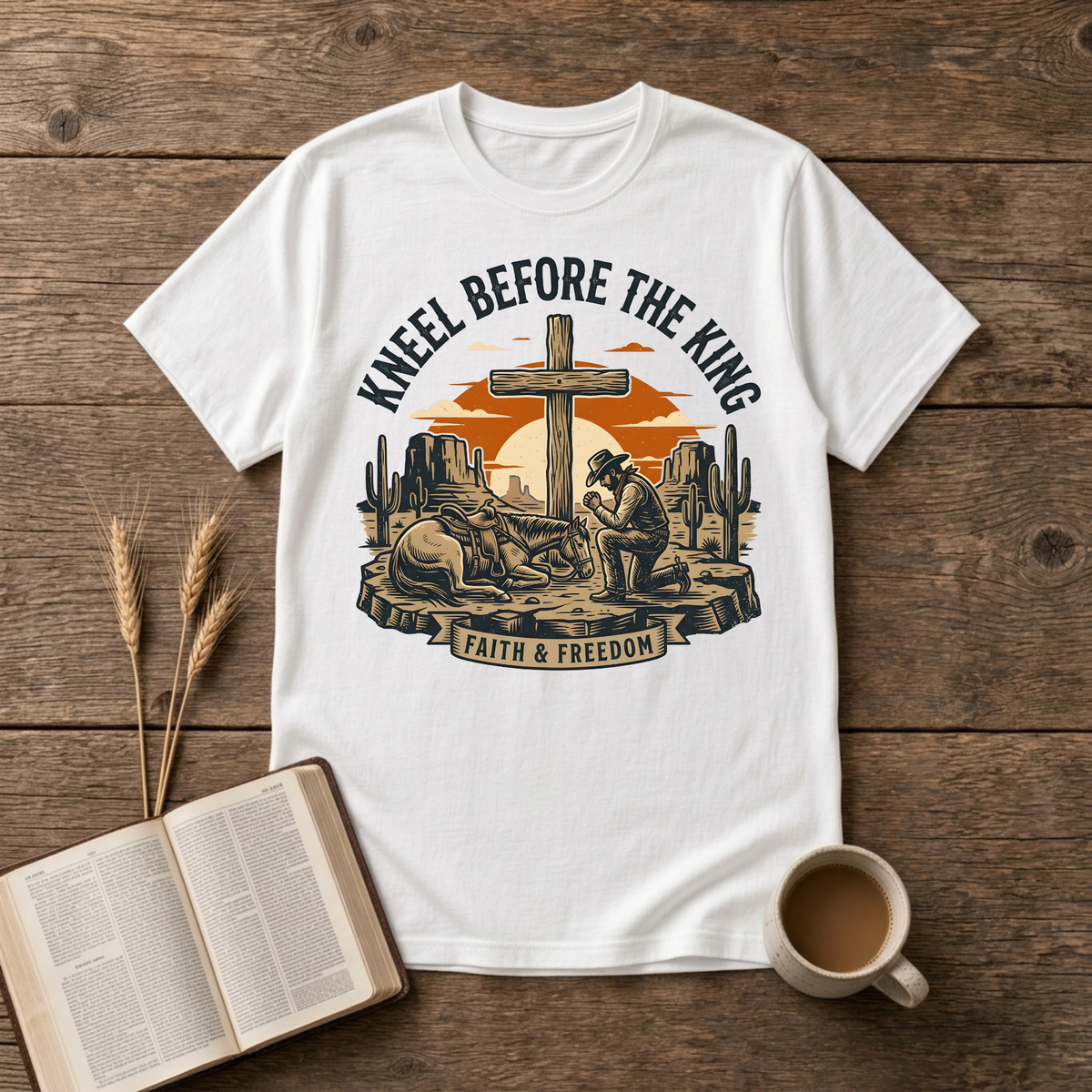 Cowboy kneeling in prayer beside his horse at a wooden cross in a desert sunset on a White unisex T-Shirt