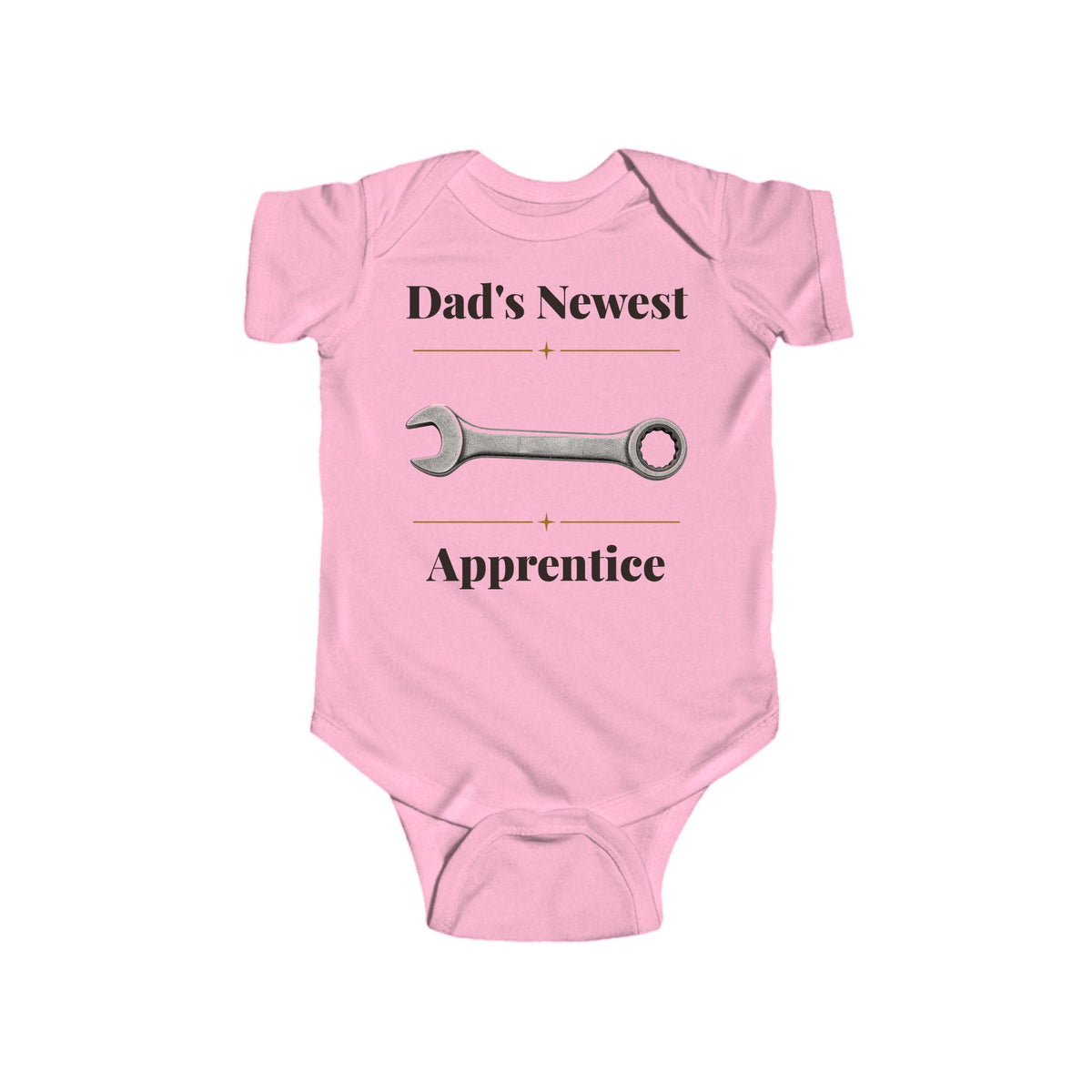 Dad's Newest Apprentice baby bodysuit in Pink on a wood table with a knit blanket, wooden rattle and open Bible