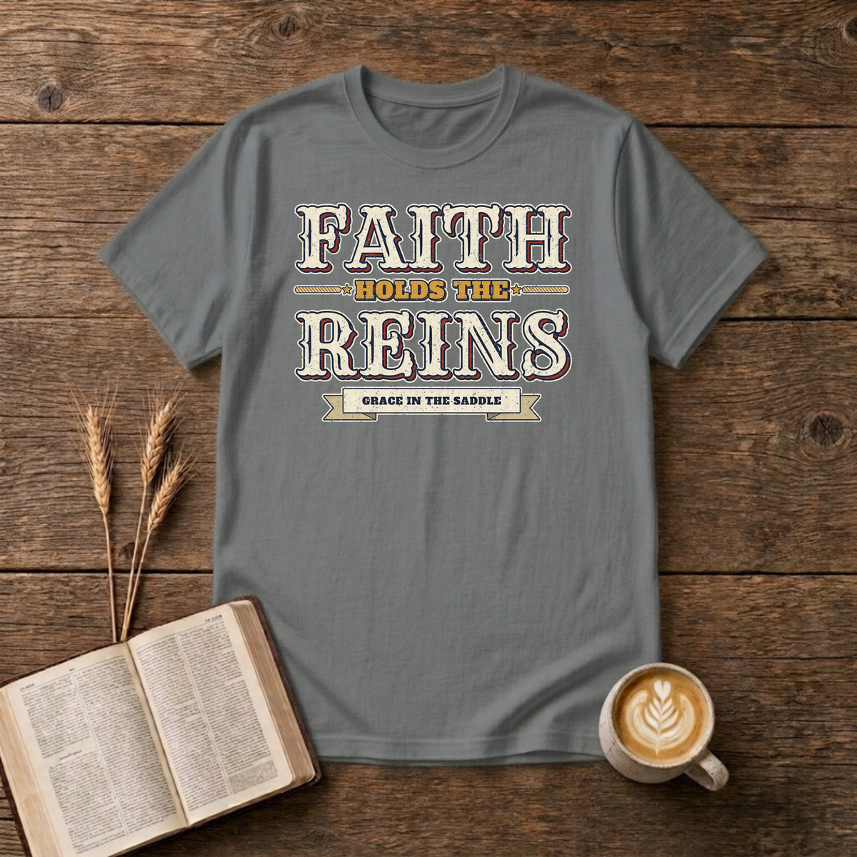 Faith Holds The Reins T-Shirt in Graphite Heather, distressed western lettering with a Grace In The Saddle banner, rope lines and stars