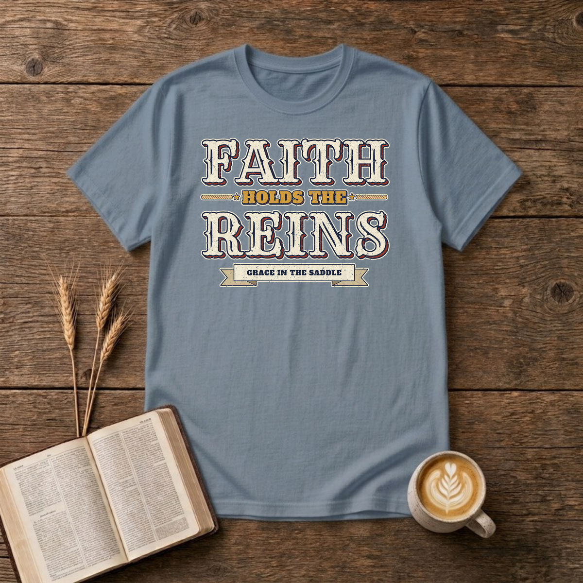 Faith Holds The Reins T-Shirt in Stone Blue, distressed western lettering with a Grace In The Saddle banner, rope lines and stars