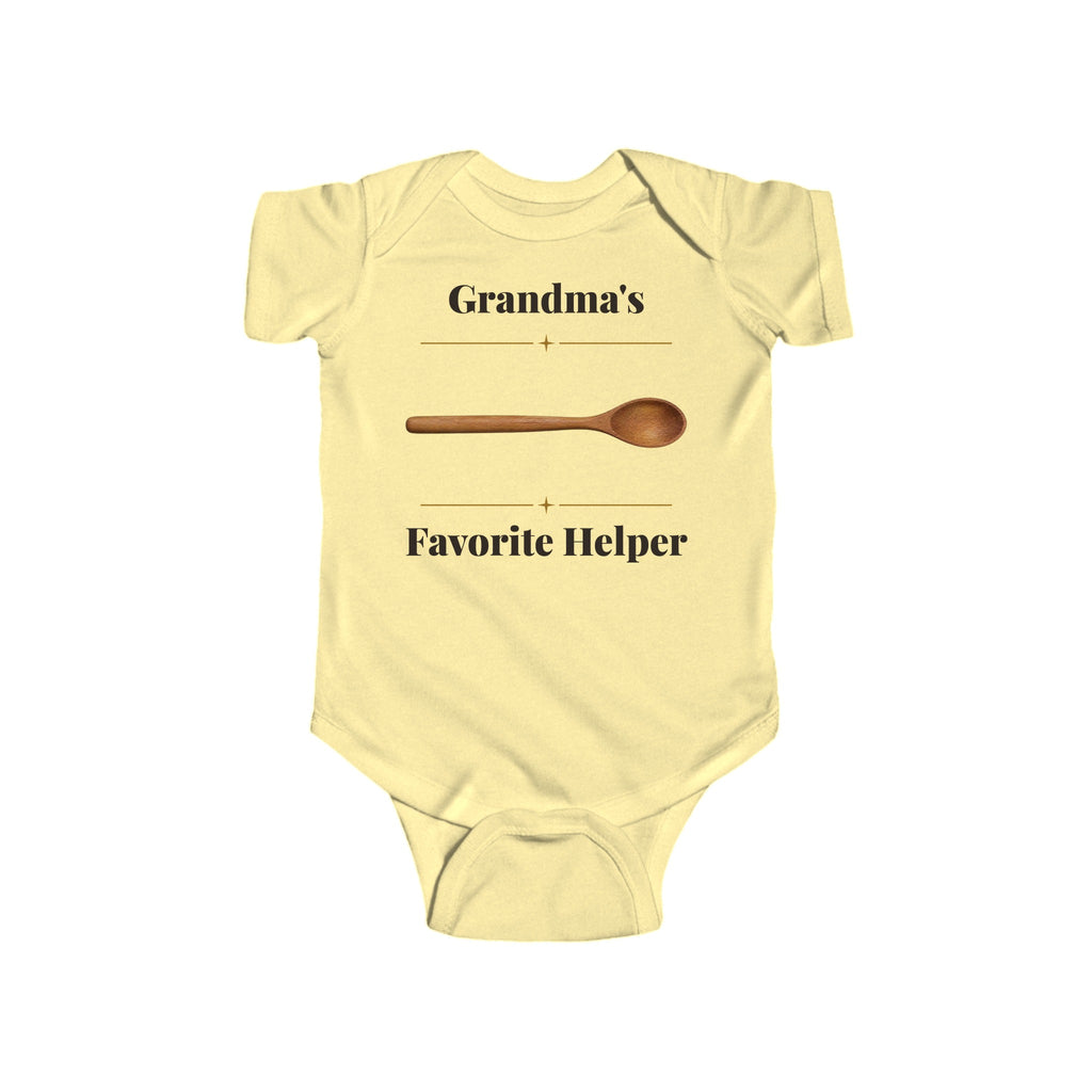 Grandma's Favorite Helper baby bodysuit in Butter on a wood table with a knit blanket, wooden rattle and open Bible