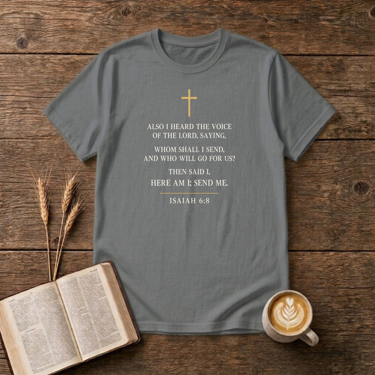 Isaiah 6:8 KJV verse "Also I heard the voice of the Lord, saying, Whom shall I send, and who will go for us? Then said I, Here am I; send me." in cream engraved type under a small gold cross on a Graphite Heather unisex T-shirt