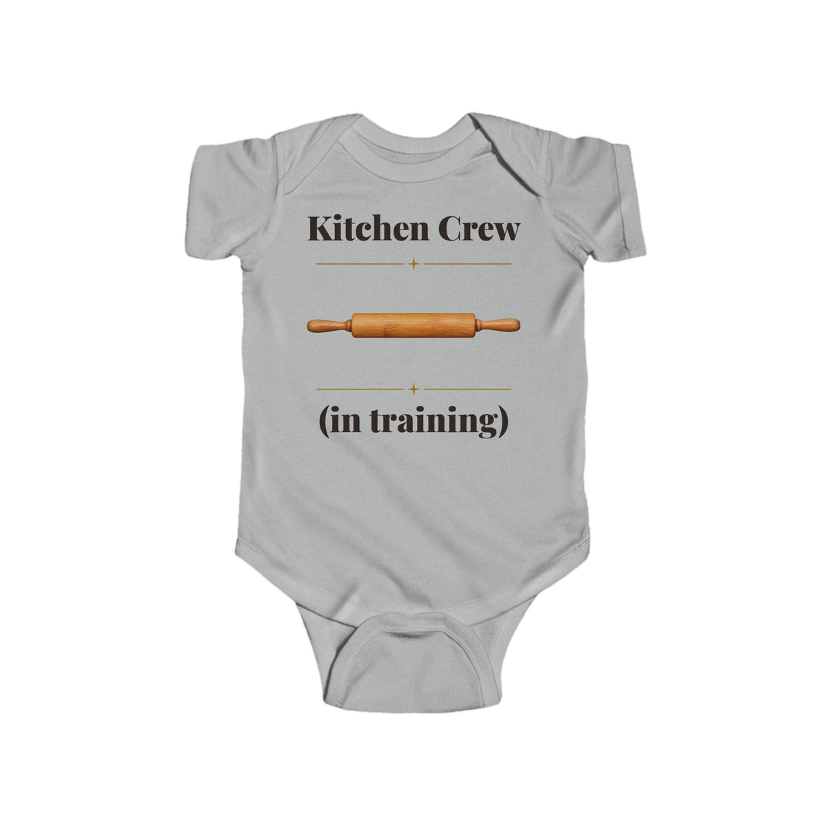 Kitchen Crew in Training baby bodysuit in Heather on a wood table with a knit blanket, wooden rattle and open Bible