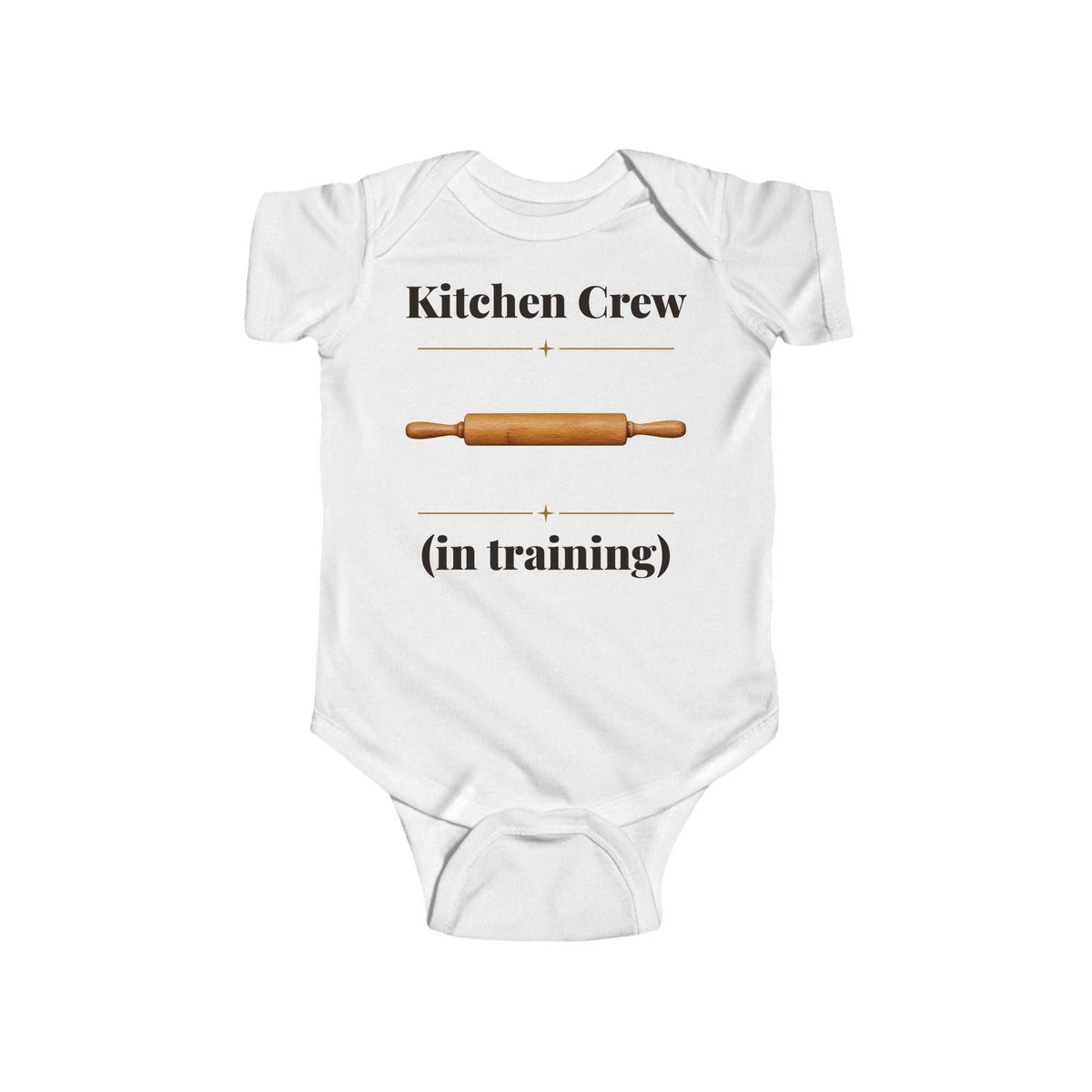 Kitchen Crew in Training baby bodysuit in White on a wood table with a knit blanket, wooden rattle and open Bible