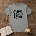 Coffee and Chaos design with black script lettering beside a steaming coffee cup on a Sport Grey unisex T-Shirt