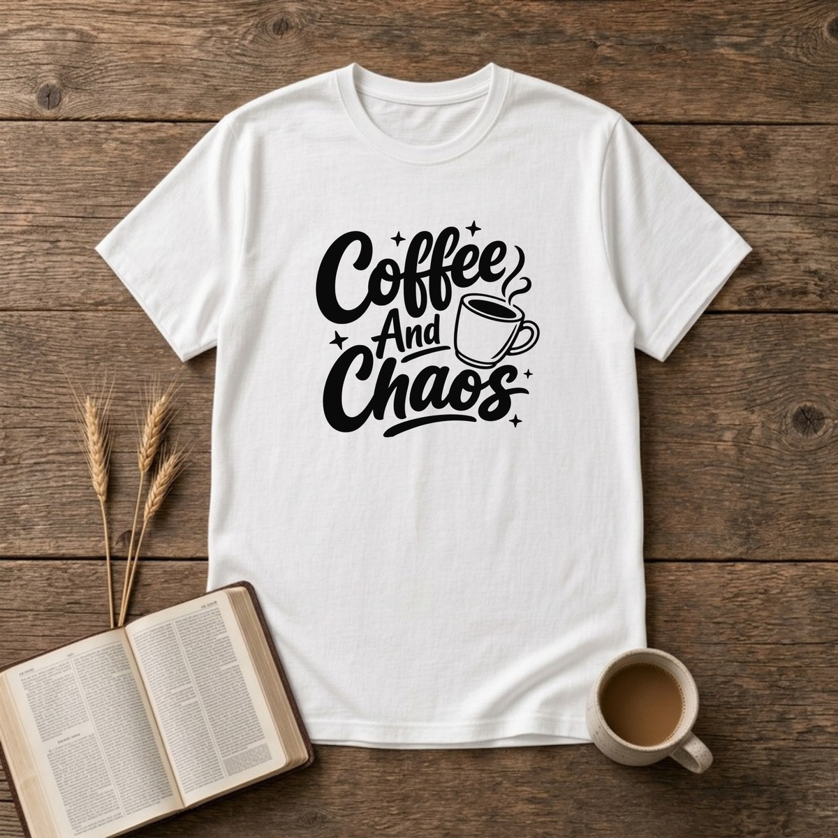 Coffee and Chaos design with black script lettering beside a steaming coffee cup on a White unisex T-Shirt