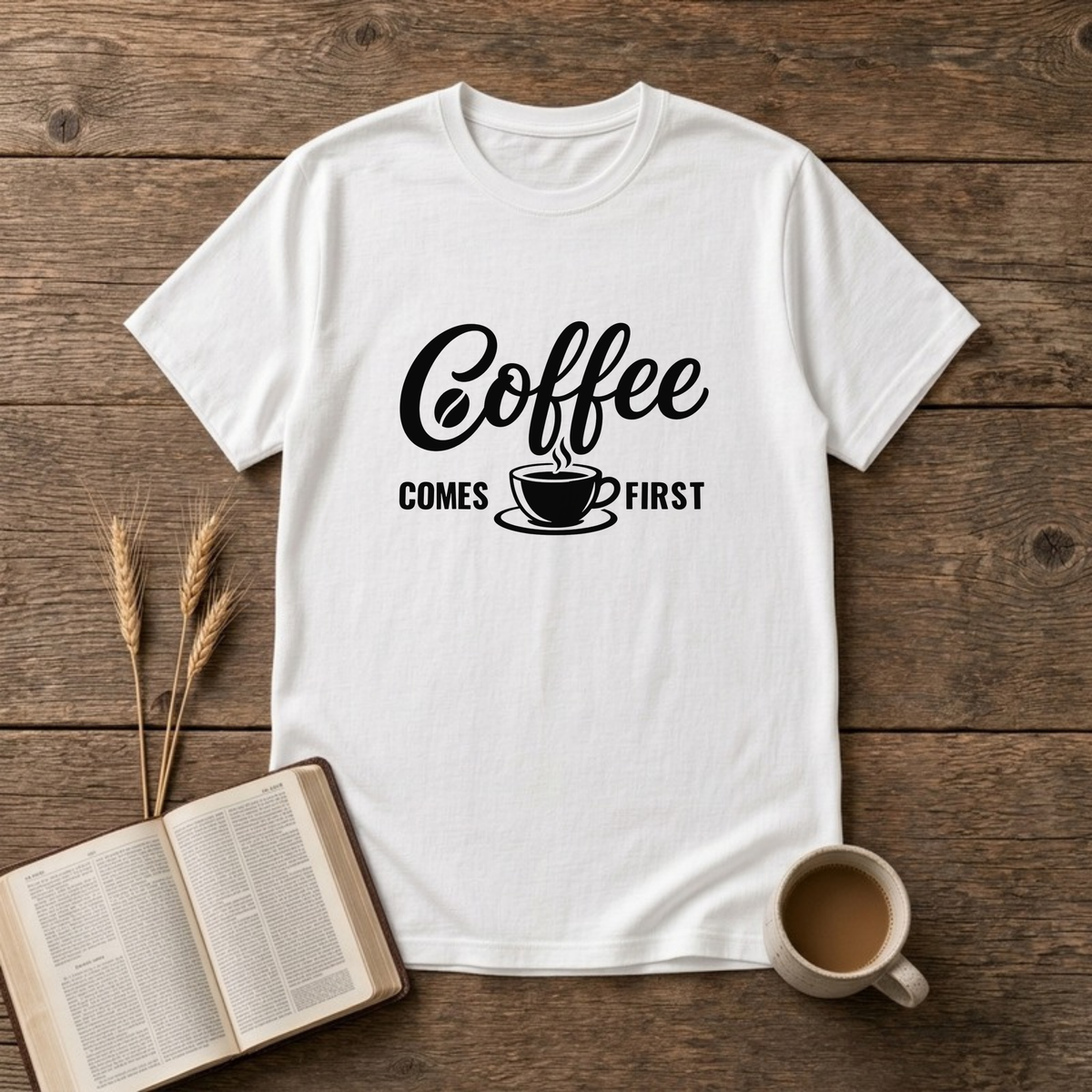 Coffee Comes First design with black script and block lettering around a steaming coffee cup on a White unisex T-Shirt