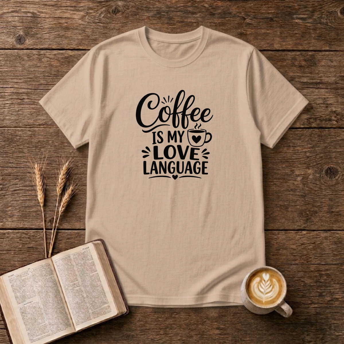 Coffee Is My Love Language design with black hand-lettered text and a heart-patterned coffee cup on a Natural unisex T-Shirt