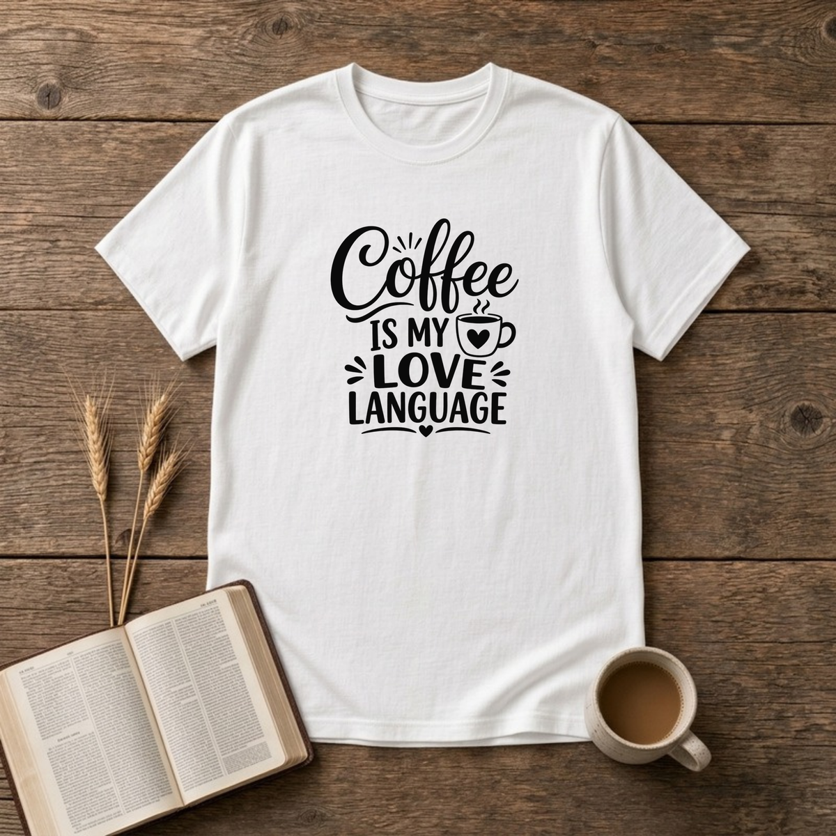 Coffee Is My Love Language design with black hand-lettered text and a heart-patterned coffee cup on a White unisex T-Shirt